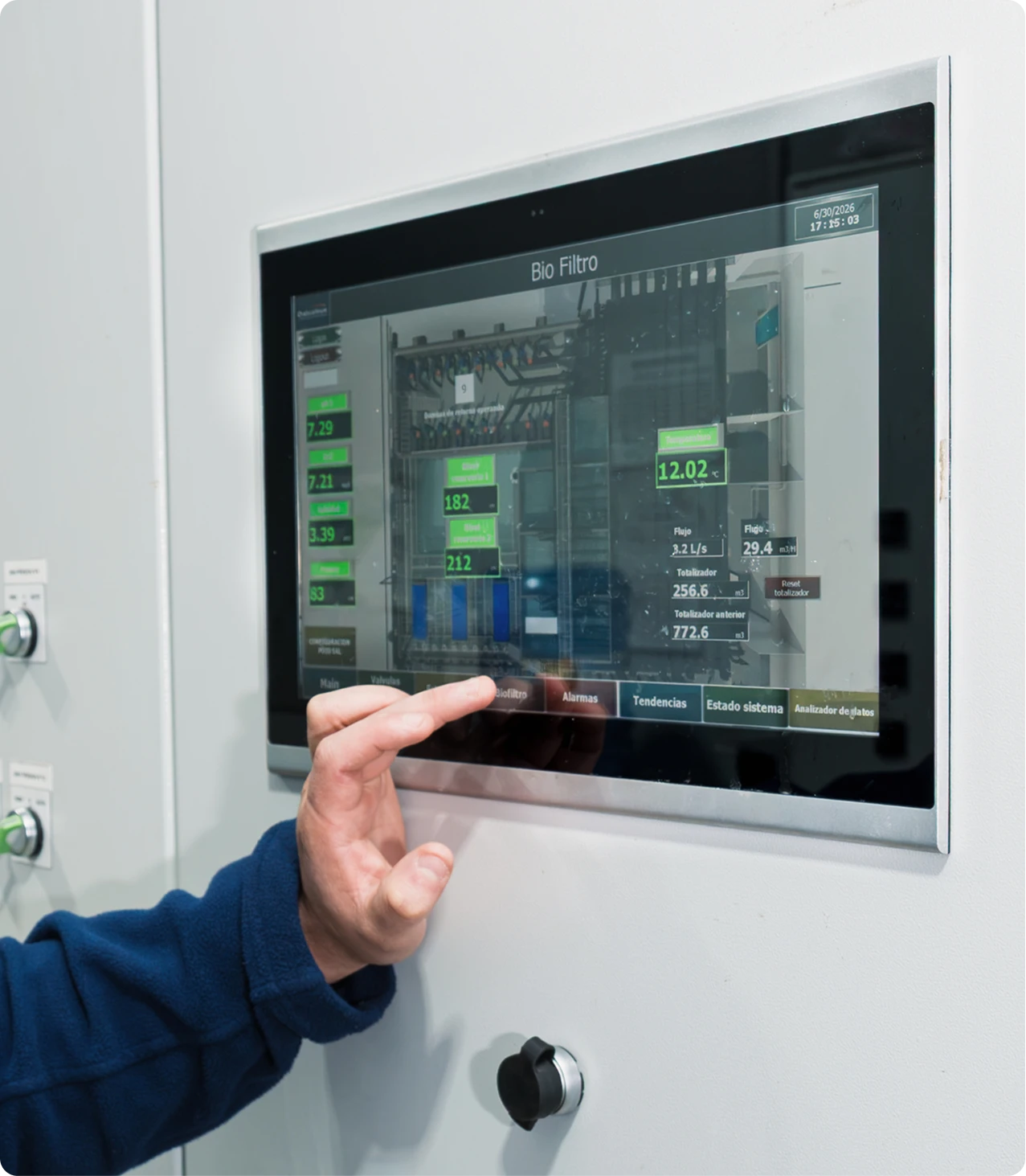 Operator adjusting biofilter variables on a touchscreen control panel