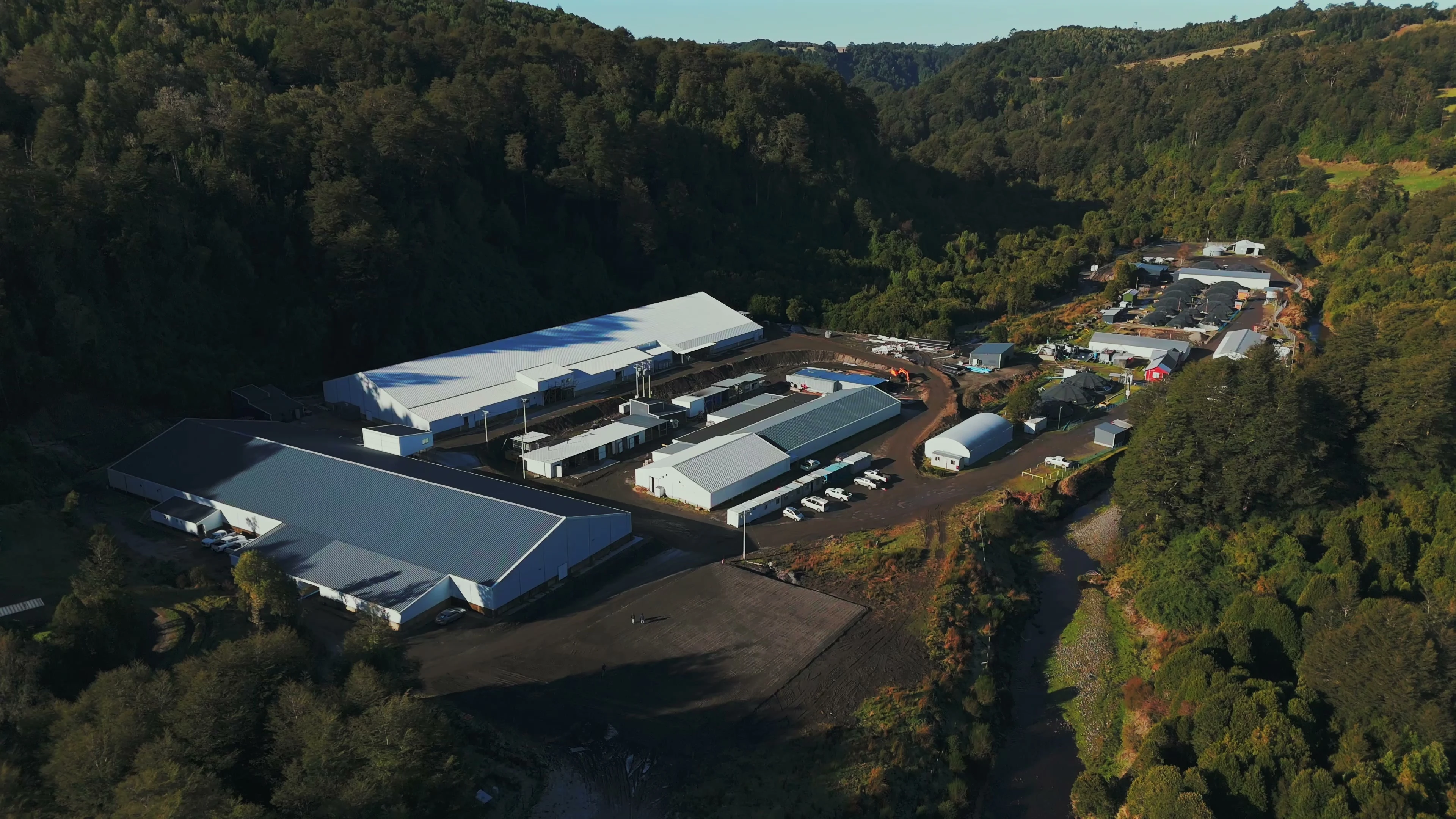 Aerial view of the Salmonífera Dalcahue plant in a forested valley
