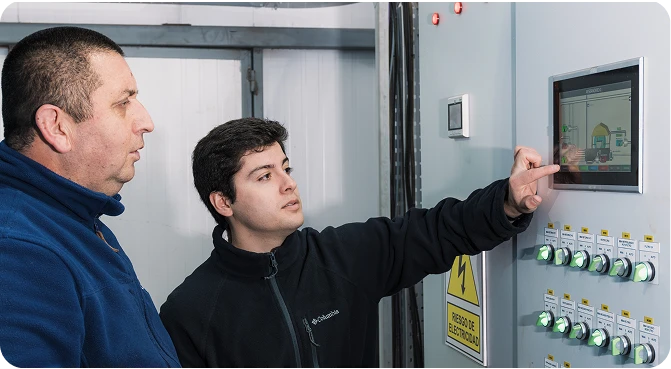 Operators supervising the control board of a farming site